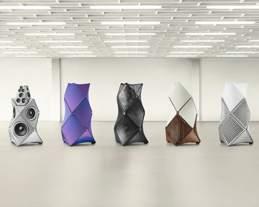 Five Bang Olufsen Beolab 90 floorstanding speakers in different Atelier finishes in a bright minimalist gallery.
