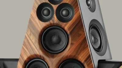 Pair of Beolab 90 Monarch and Zenith editions with pearl-studded panels and one speaker showing exposed driver array.