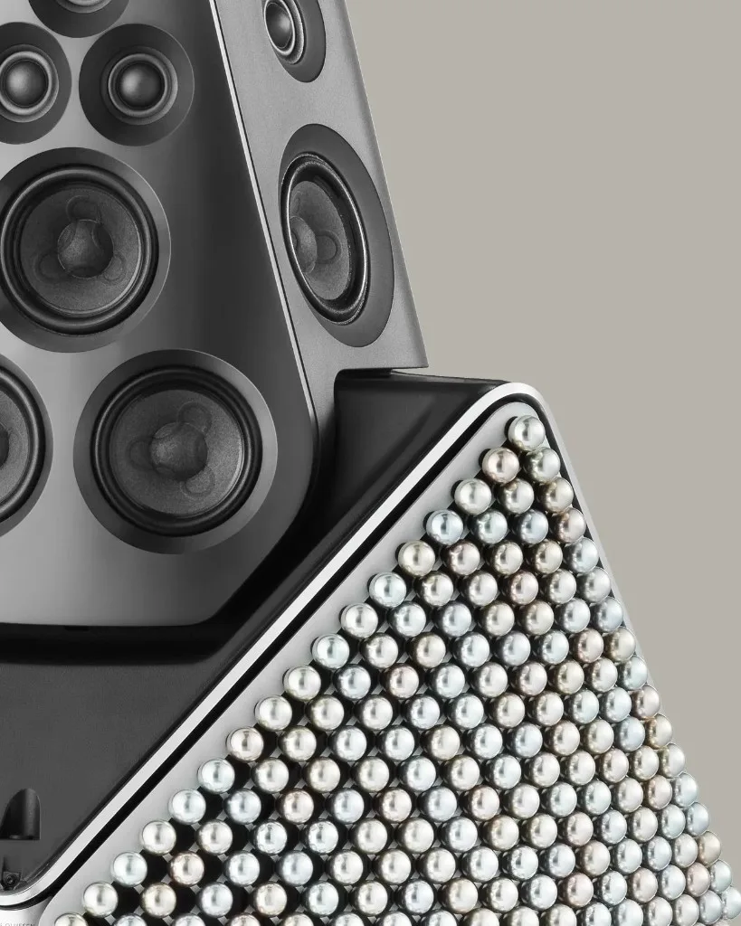 Vertical close-up of Beolab 90 Zenith Edition driver head above an iridescent pearl-inlaid geometric panel.