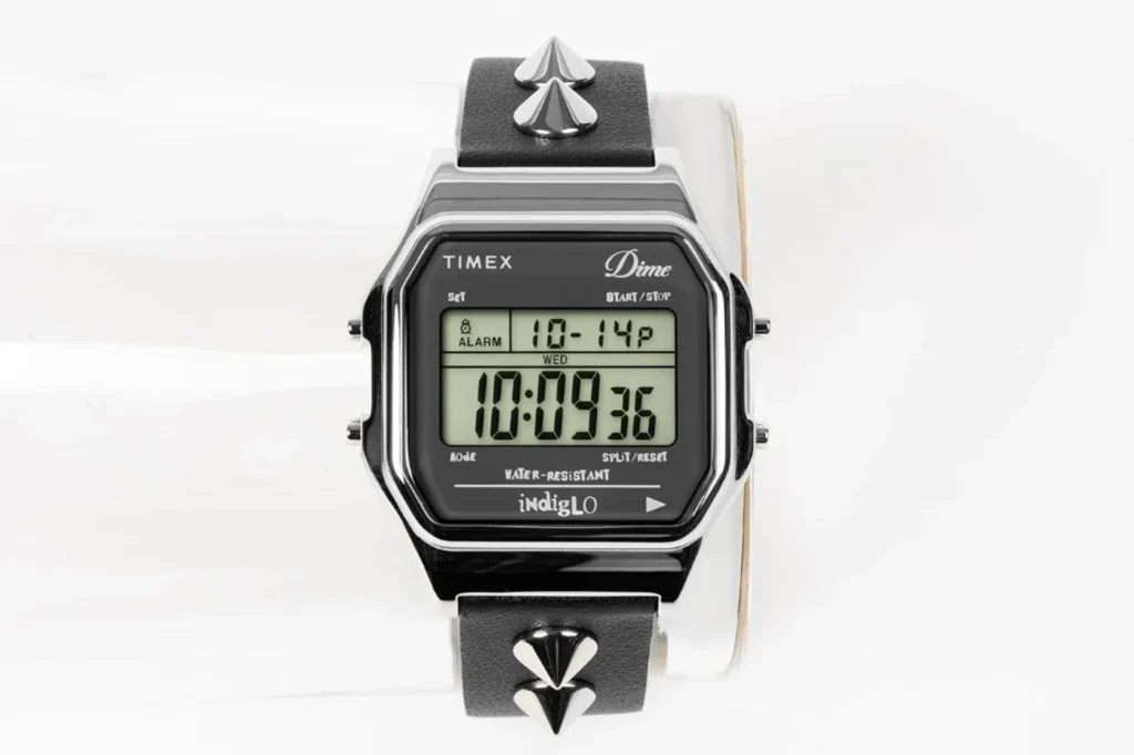 Dime x Timex T80 with black leather strap and vertical silver cone studs, chrome octagonal case, digital display with alarm…