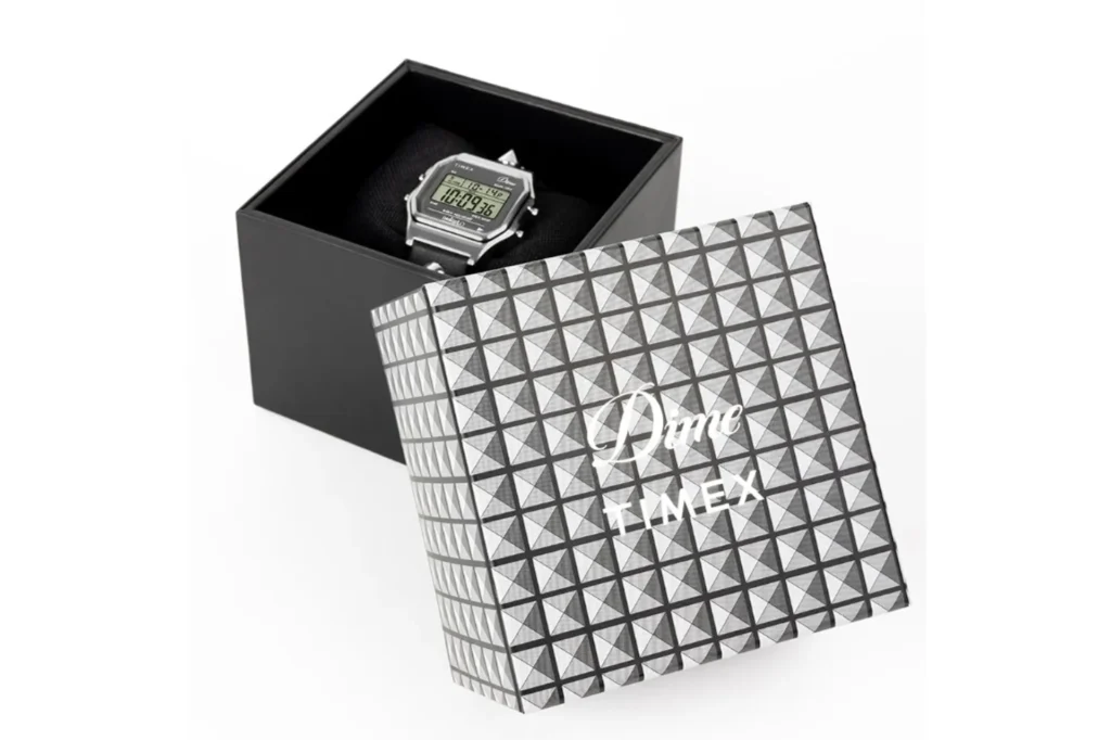 Dime x Timex T80 in black gift box with pyramid-textured lid showing Dime script and Timex wordmark; watch with digital disp…