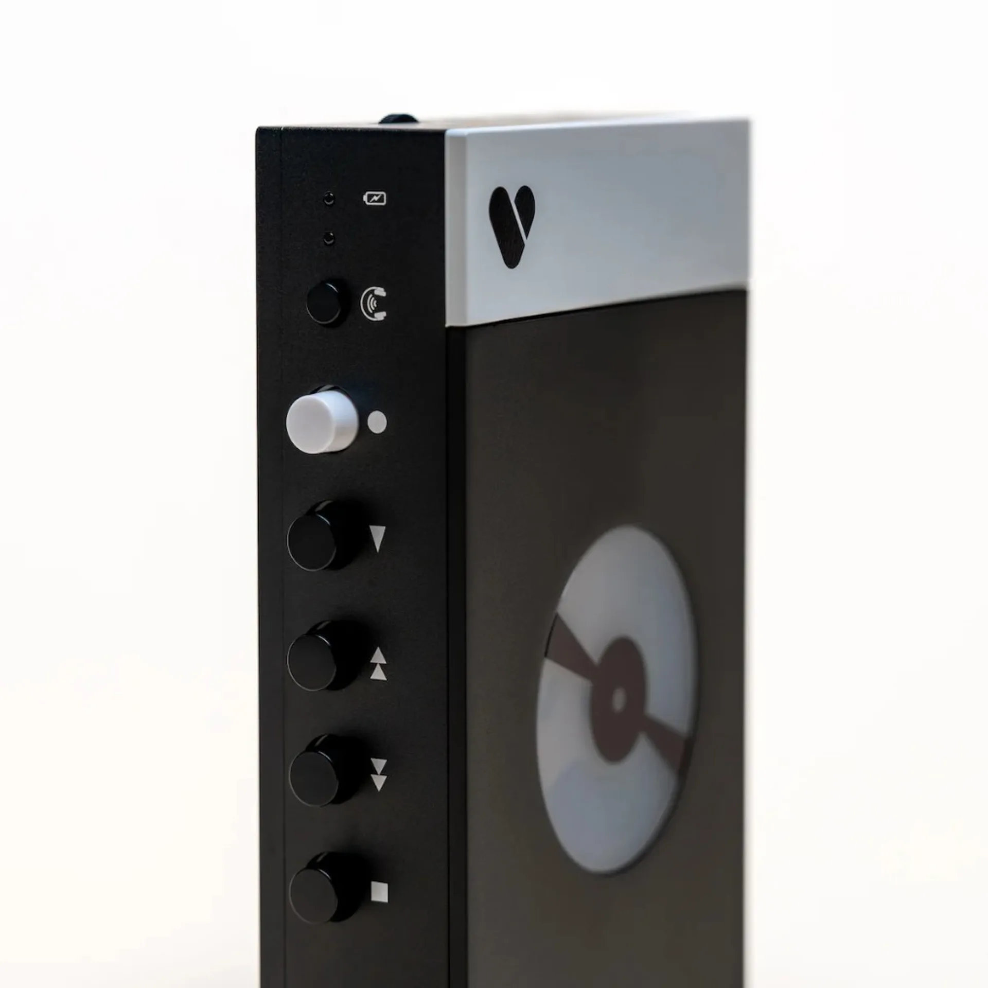 We Are Rewind portable player side: white top panel with heart logo, white volume knob, black play rewind fast-forward stop buttons, frosted tape window.