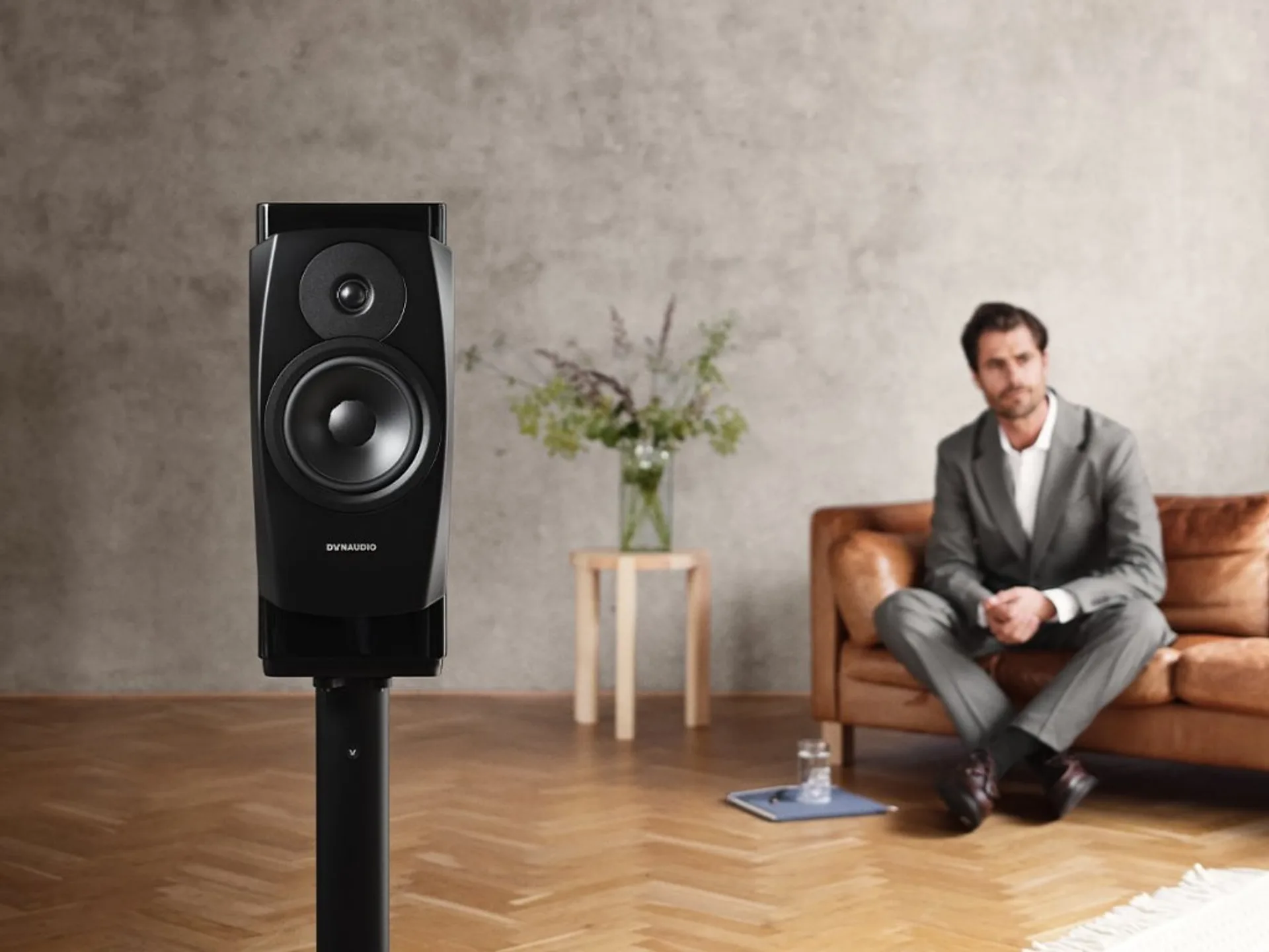 Dynaudio Confidence 20A active speaker on a dedicated stand in a modern listening room.