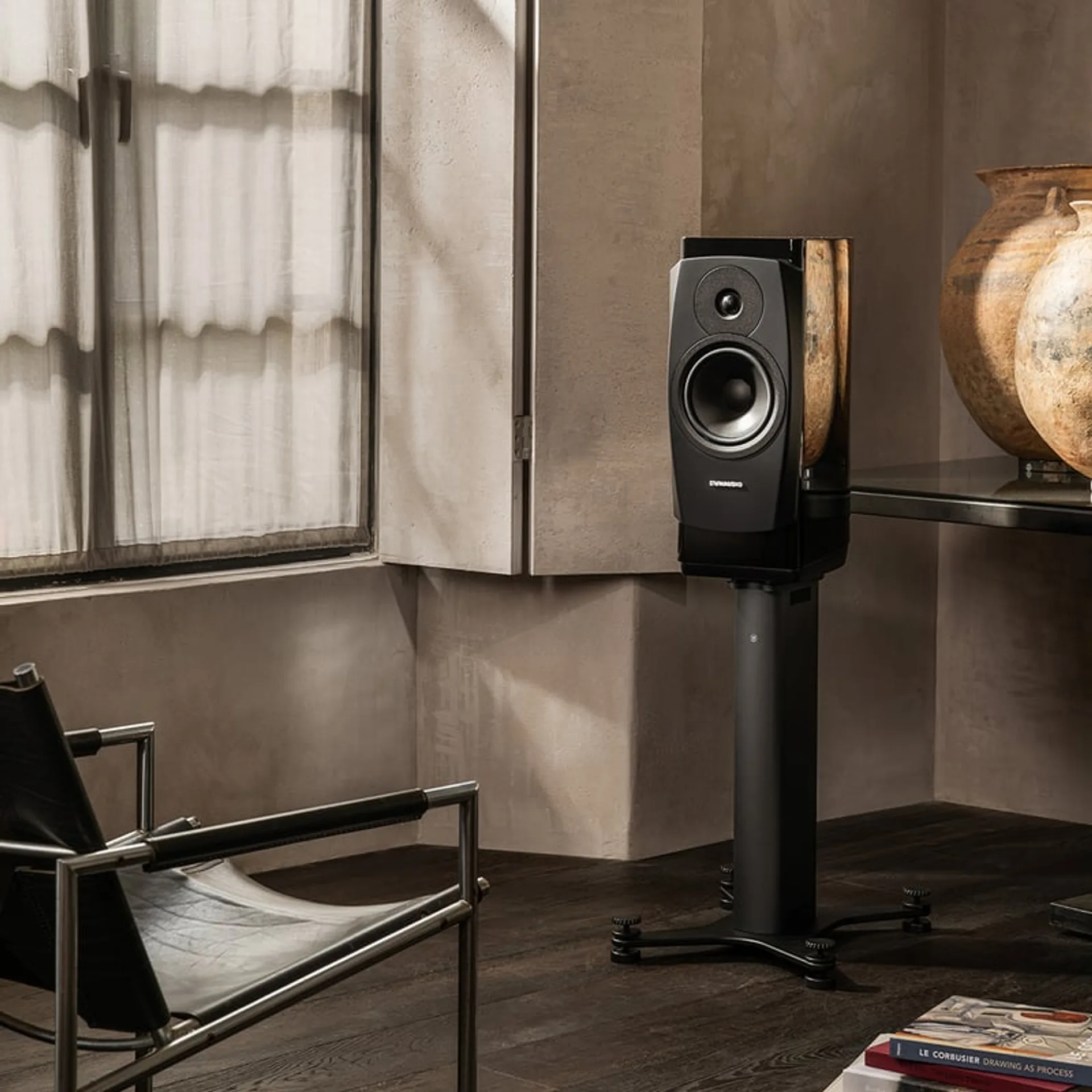 Dynaudio Confidence 20A in a living room near a window, showing real-world placement.