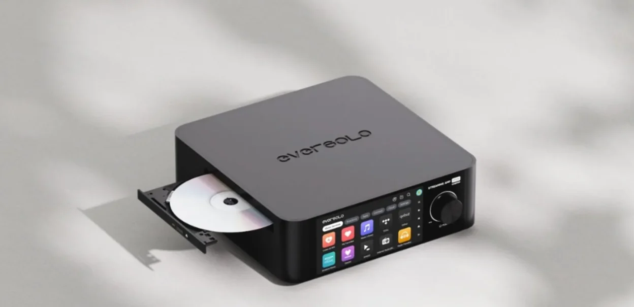 Eversolo all-in-one streaming amplifier with open CD tray, touchscreen Music Services menu and matte black finish on gray su…