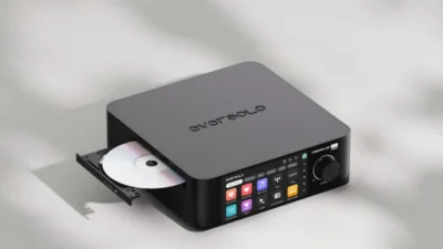 Eversolo all-in-one streaming amplifier with open CD tray, touchscreen Music Services menu and matte black finish on gray su…