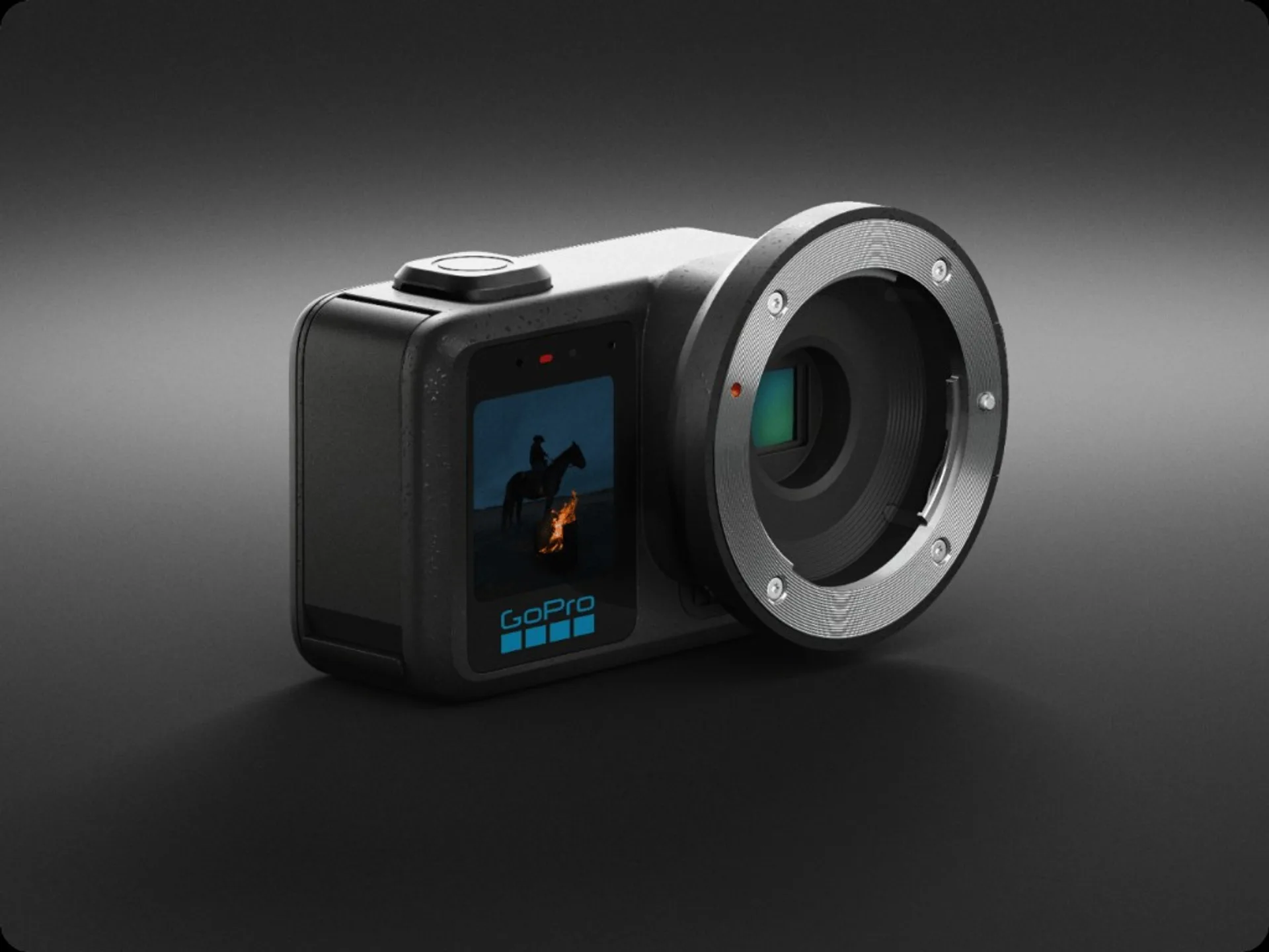 GoPro Mission 1 concept render: matte black action camera body with large silver interchangeable lens mount, front screen pr…