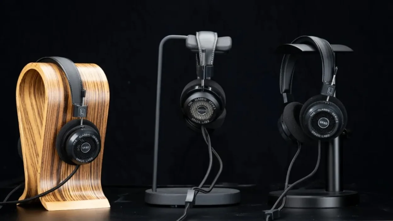 Three Grado Labs Classic Series open-back headphones on stands: SR80 on wooden stand, SR325 center on metal stand, SR60 on b…