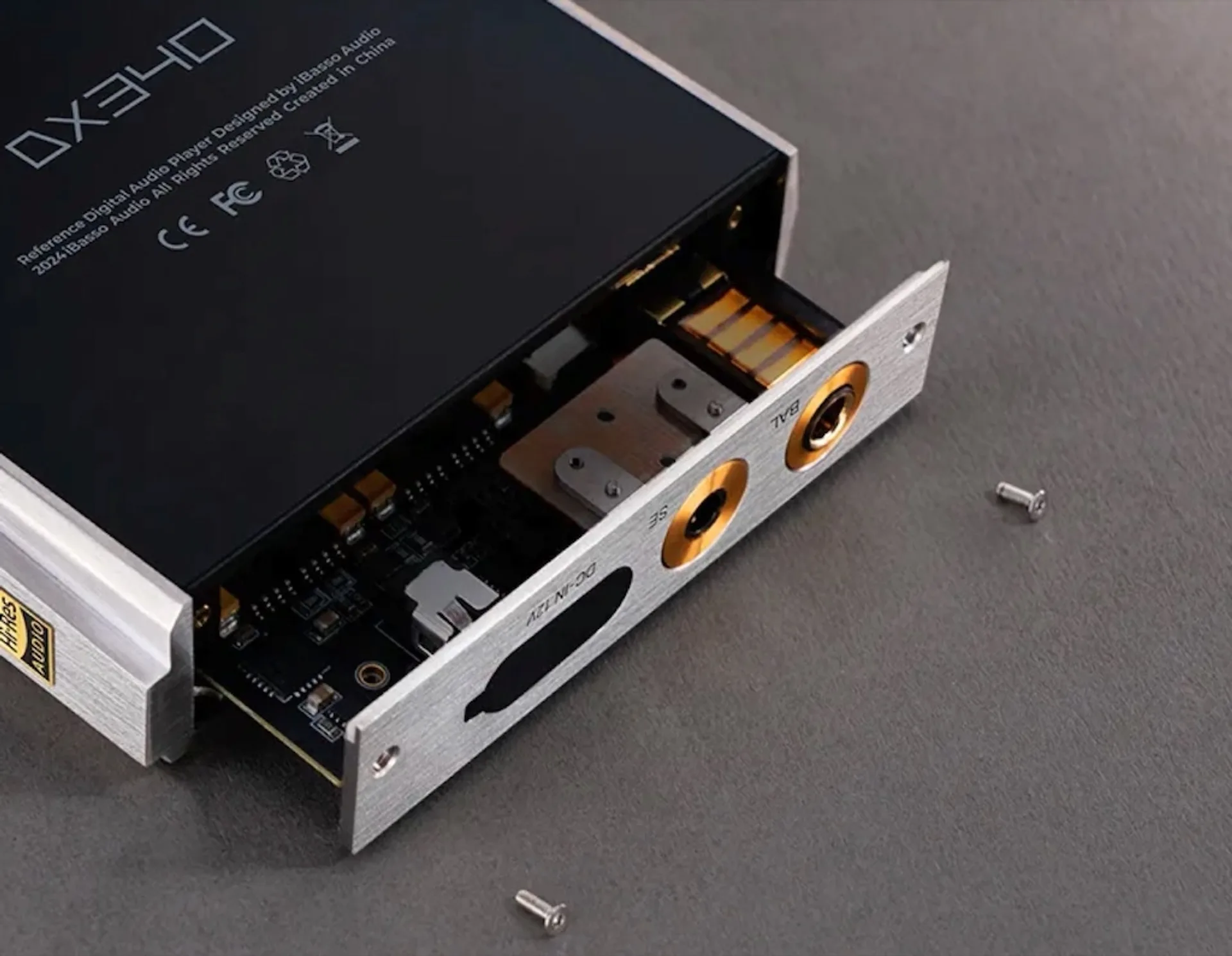 iBasso DX340 Reference DAP with bottom amplifier module partially removed, showing SE and BAL jacks and internal PCB.