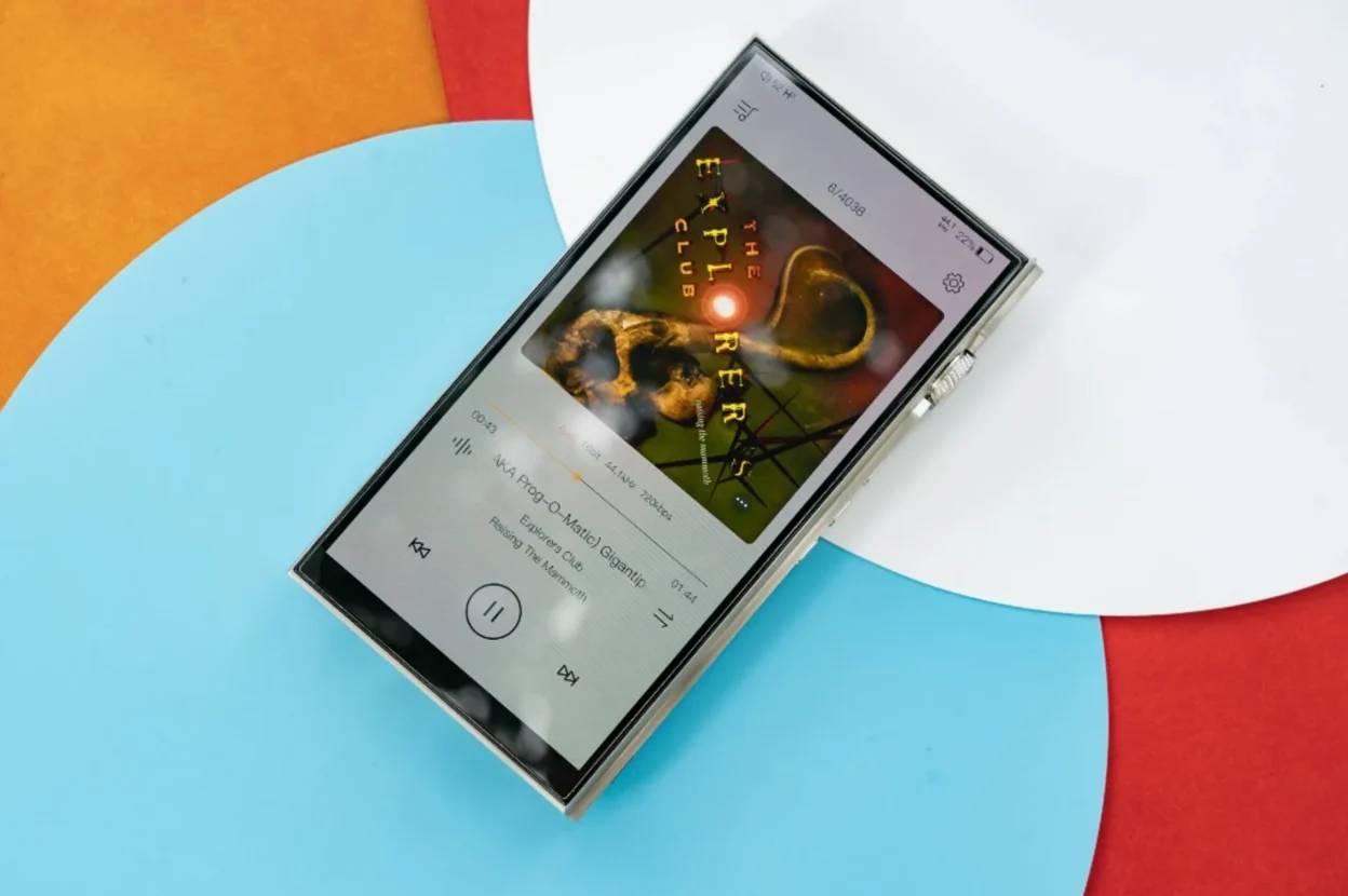 iBasso DX340 DAP displaying FLAC playback interface with album art on a multicolor circular background.