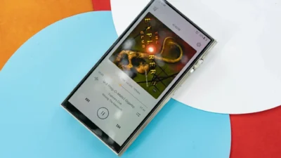 iBasso DX340 DAP displaying FLAC playback interface with album art on a multicolor circular background.