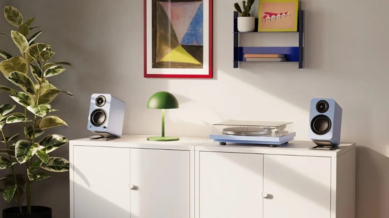 Kanto YU bookshelf speakers in pastel light blue on silver stands with matching light blue turntable on a white sideboard, m…