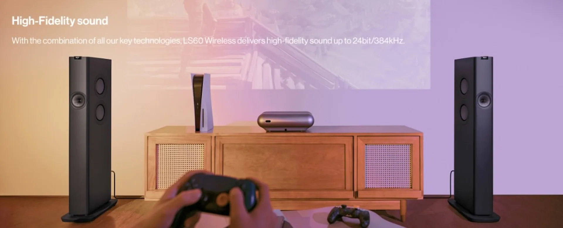 KEF LS60 Wireless pair in a TV and gaming room setup with minimal external equipment.