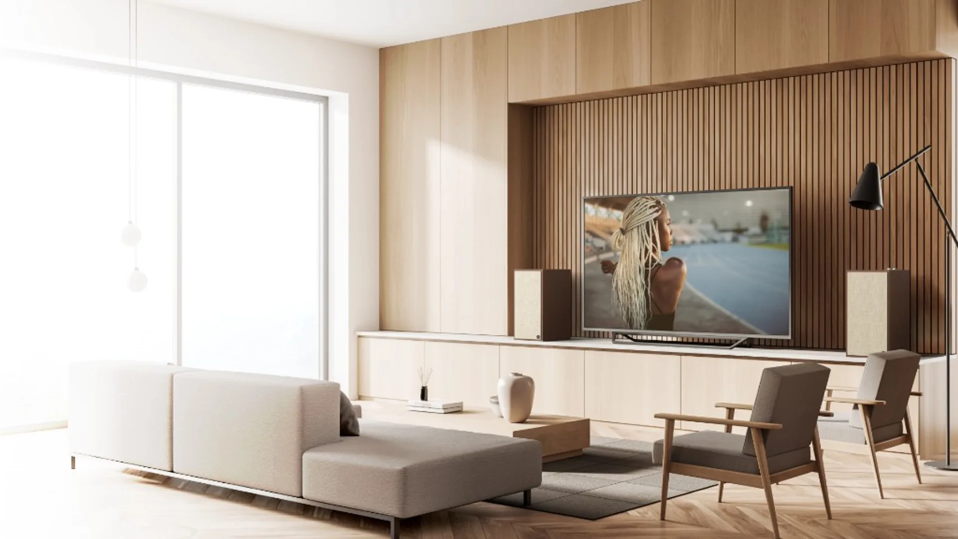 Klipsch The Sevens in a bright living room TV setup with two bookshelf speakers flanking the television.