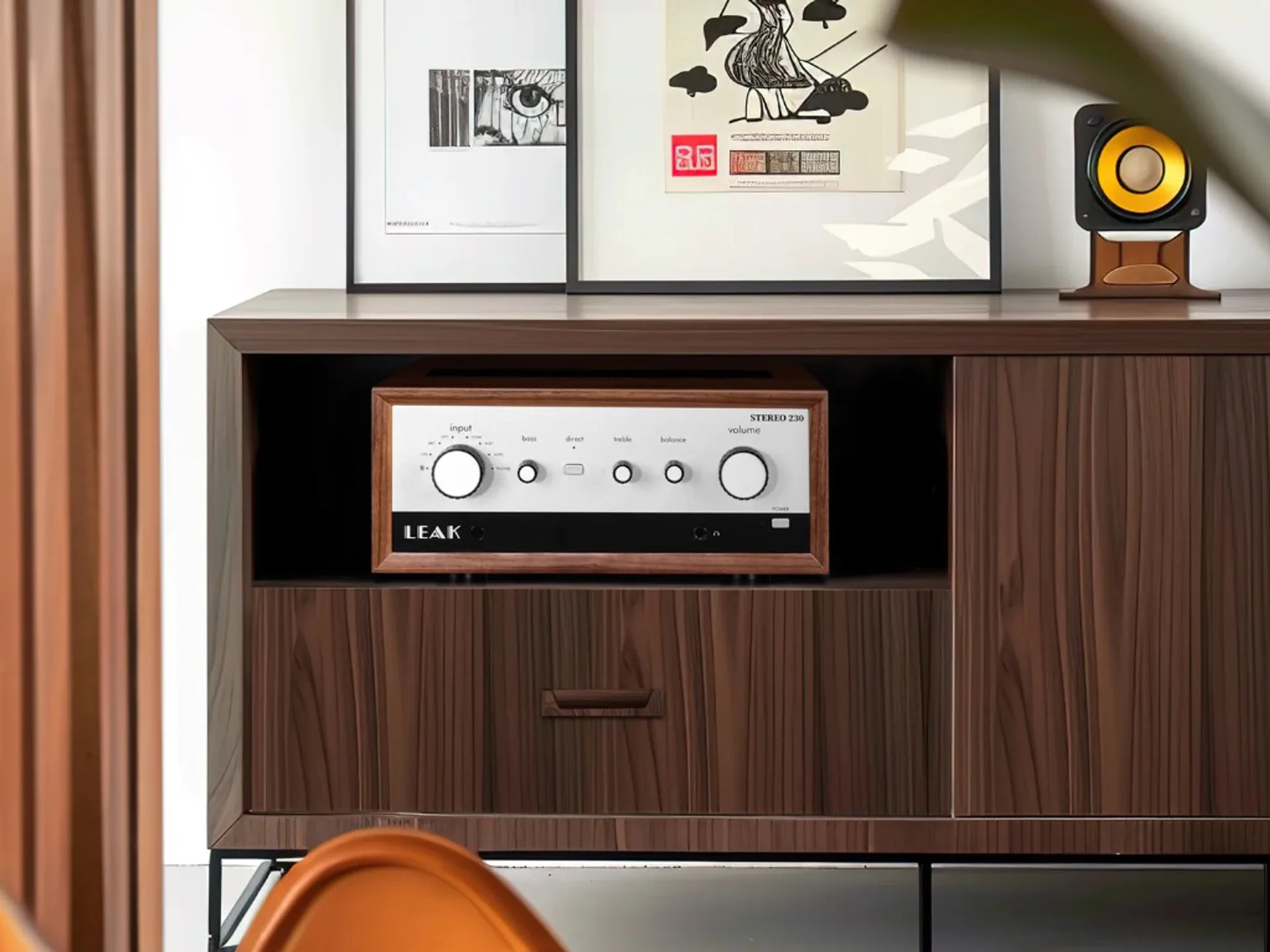 LEAK Stereo 230 placed inside a wooden media cabinet in a home listening setup.