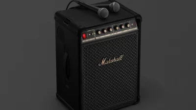Marshall Bromley 450 party speaker with two wired microphones on top, black tolex, gold control panel and script logo on gri…