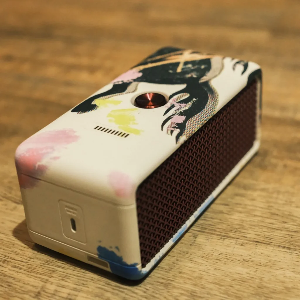 Marshall Emberton III Lunar New Year 2026 side view: honeycomb grille, USB-C port, art-finished casing on light wood.