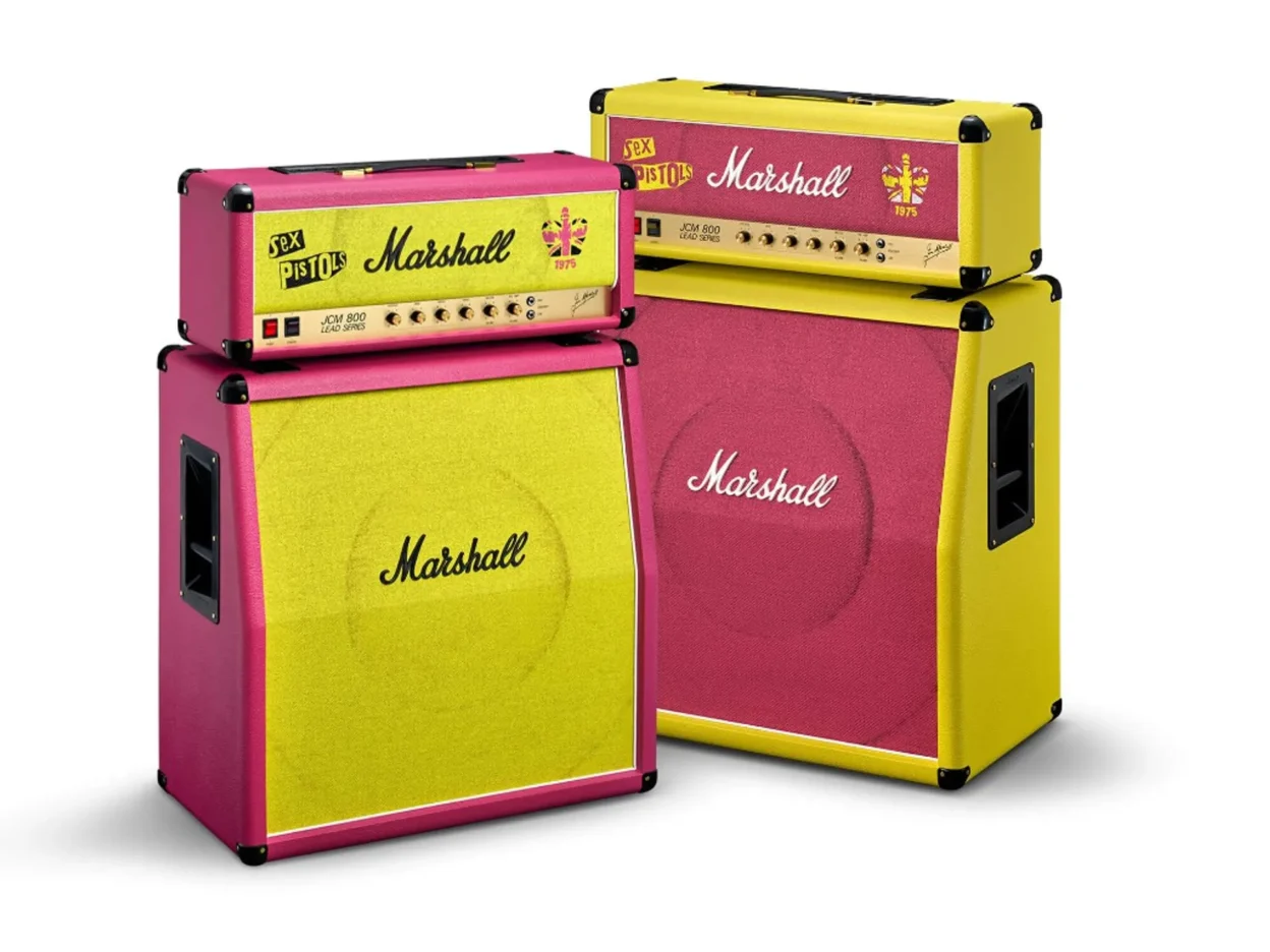 Two Marshall x Sex Pistols JCM800 stacks side by side: one pink chassis with yellow grille, one yellow chassis with pink gri…