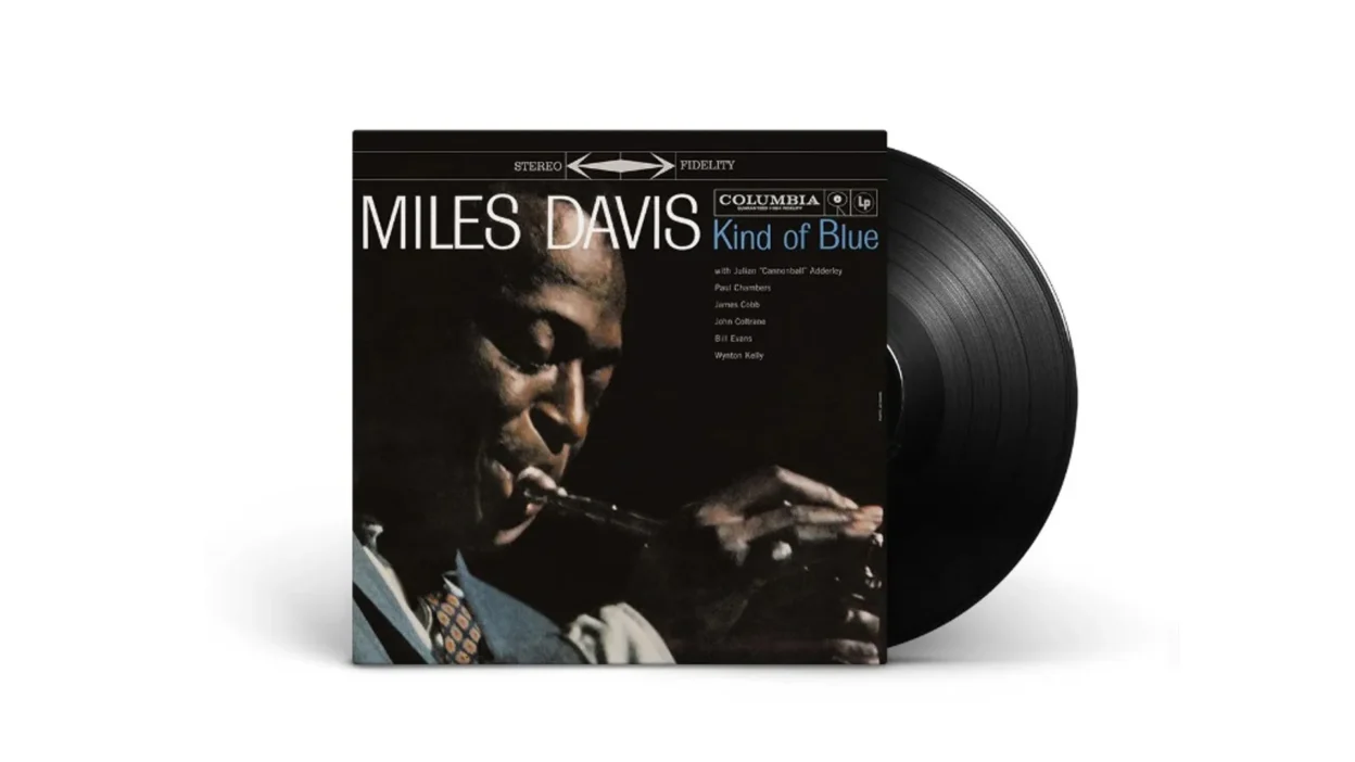 Miles Davis Kind of Blue album sleeve with black vinyl LP partially slid out on white background, Columbia stereo fidelity c…