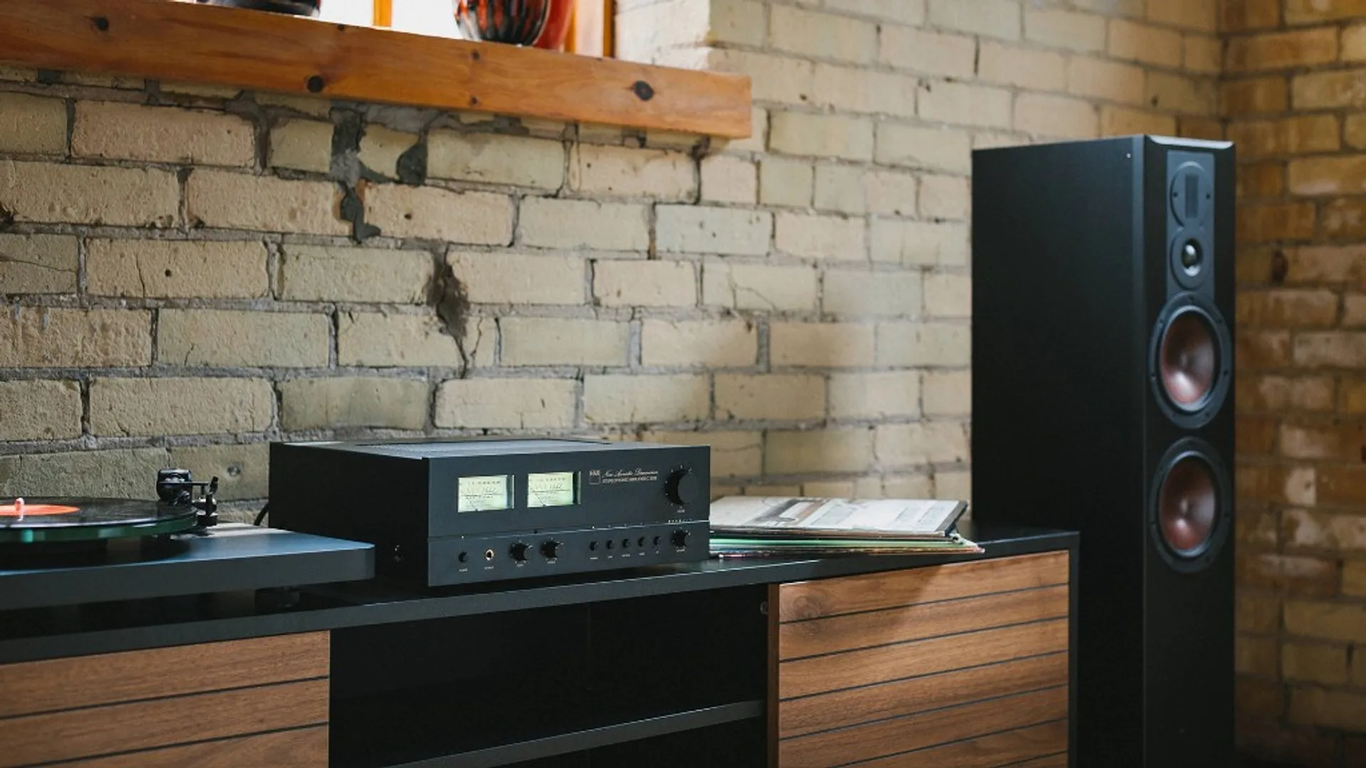 NAD C 3030 integrated amplifier in a room setup with a floorstanding speaker.