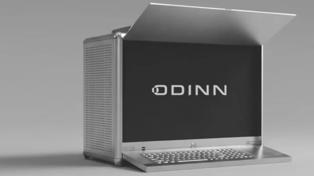 ODINN portable workstation with screen showing ODINN logo, metallic sun hood, ventilated chassis, and fold-out keyboard.