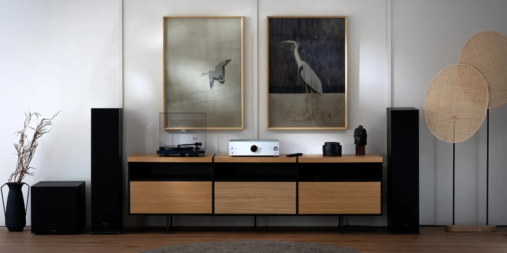 Minimalist living room with silver Onkyo Icon A-50 integrated amp, turntable, Klipsch floorstanders, and crane art on the wall.