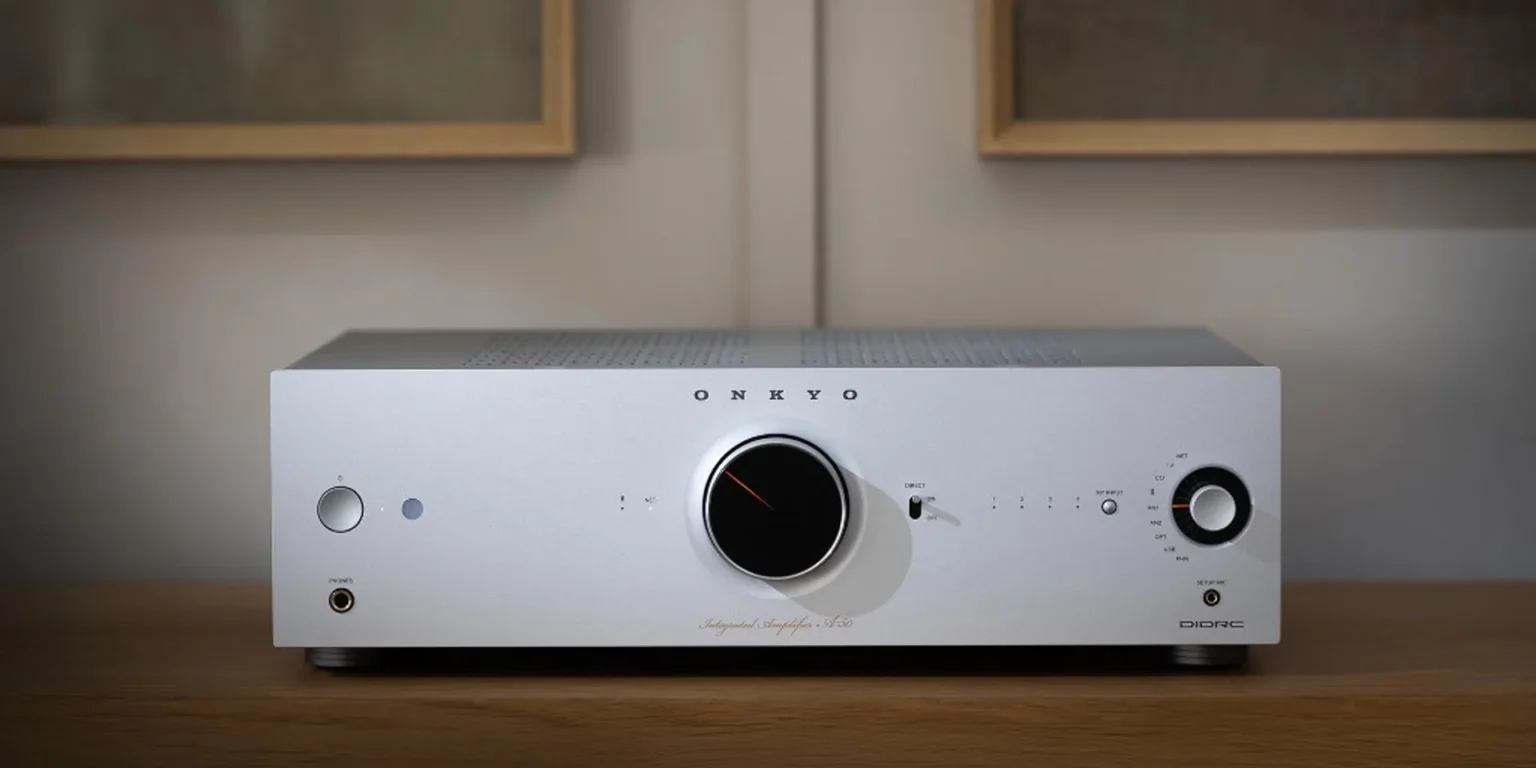 Silver Onkyo Icon A-50 integrated amplifier front panel close-up on a modern wooden cabinet.