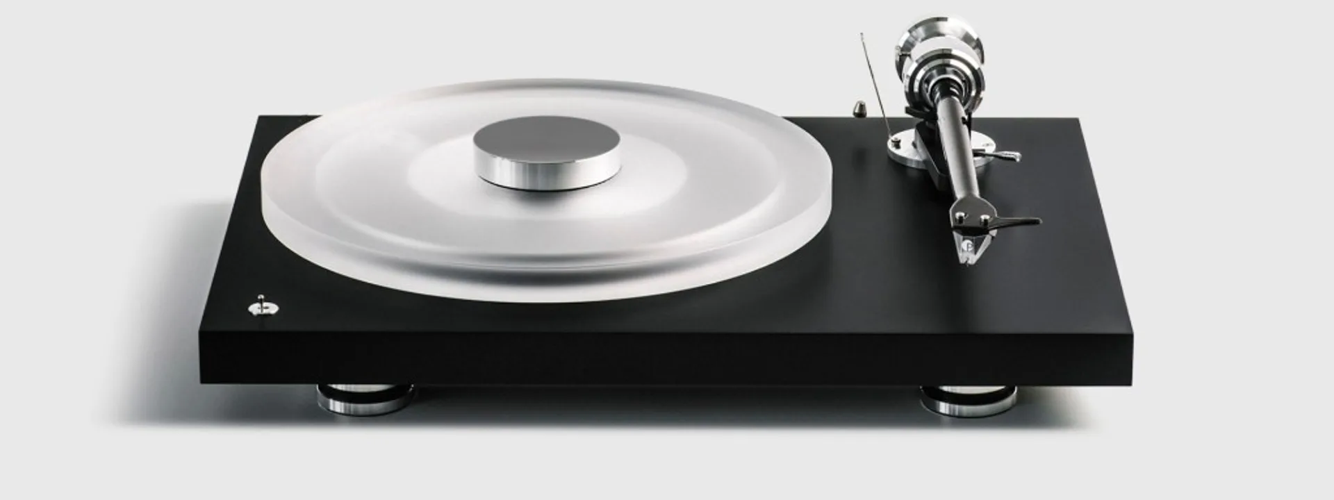 Pro-Ject Debut Reference 10 turntable front three-quarter: matte black plinth, frosted acrylic platter with chrome stabilize…