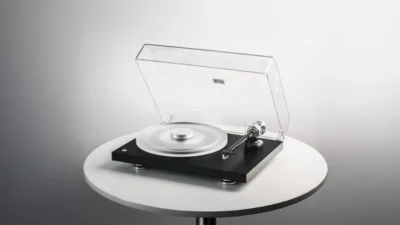 Pro-Ject Debut Reference 10 turntable with matte black plinth, frosted acrylic platter, silver record weight, clear dust cov…