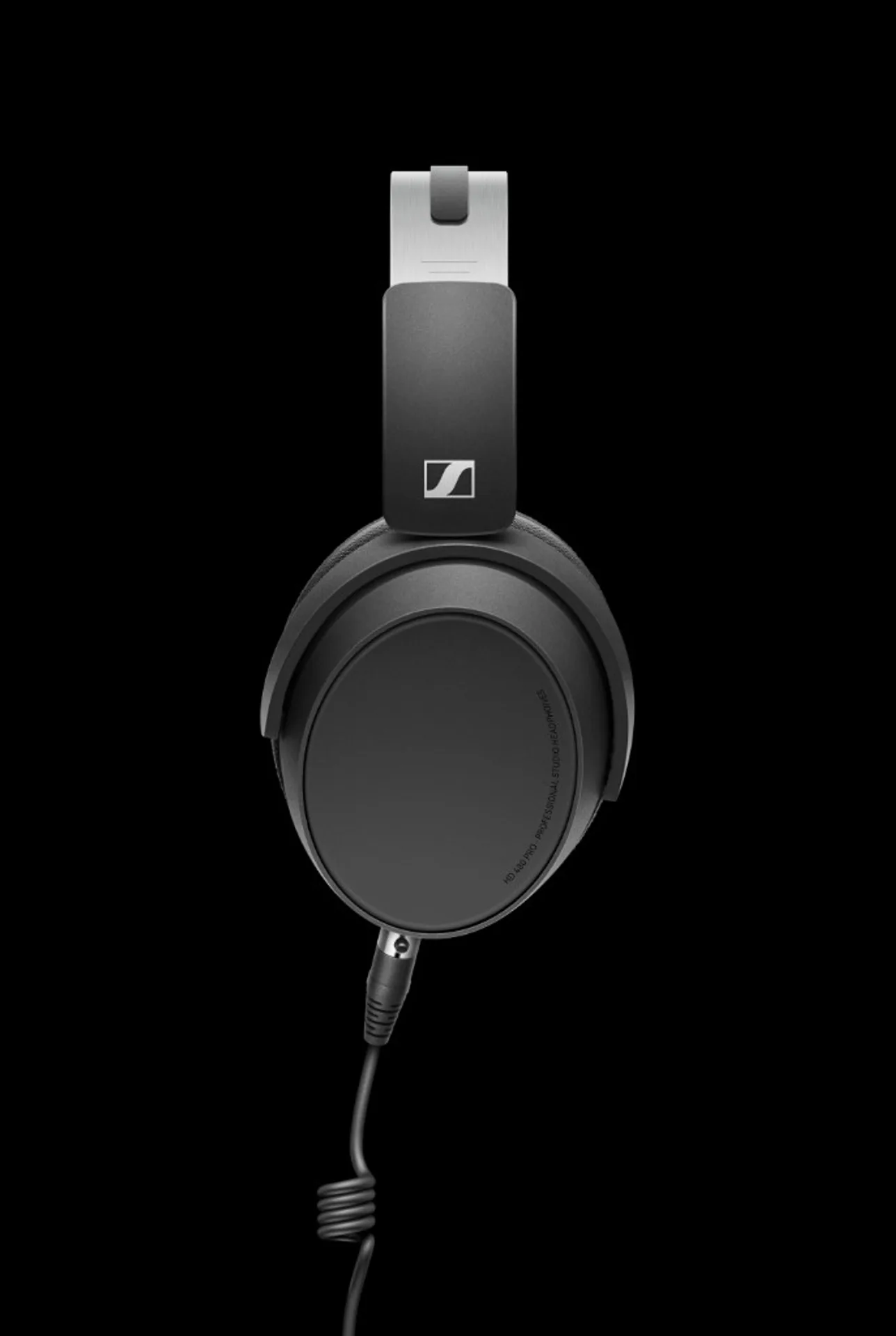 Sennheiser HD 480 PRO side profile: matte earcup, silver headband slider, Sennheiser logo, coiled cable on black background.