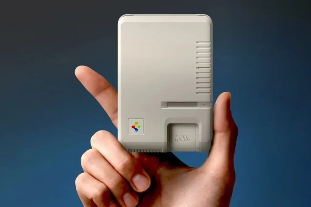 Hand holding a small beige Spigen accessory styled like a classic Macintosh with hello script and retro vents.