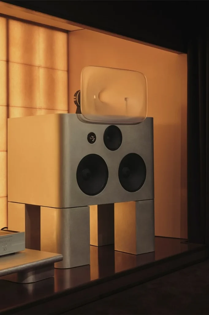 Friendly Pressure style floorstanding speaker with resin horn, warm backlit grid wall, Spotify Listening Lounge London.