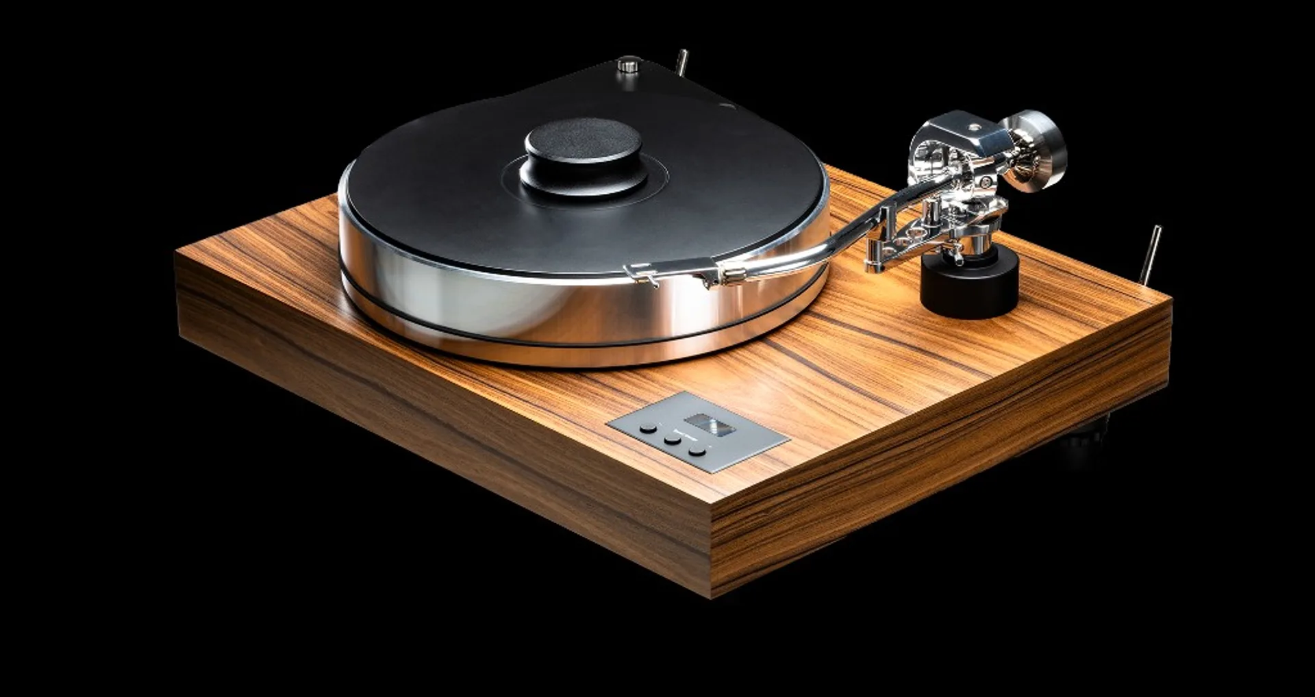 Close-up of black Sumiko phono cartridge with teal stylus guard tracking a white vinyl record.