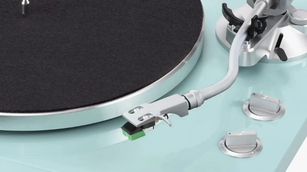 TEAC TN-400BT-X on a light wood shelf playing a record, coffee setup and plant, bright minimalist room lifestyle shot.