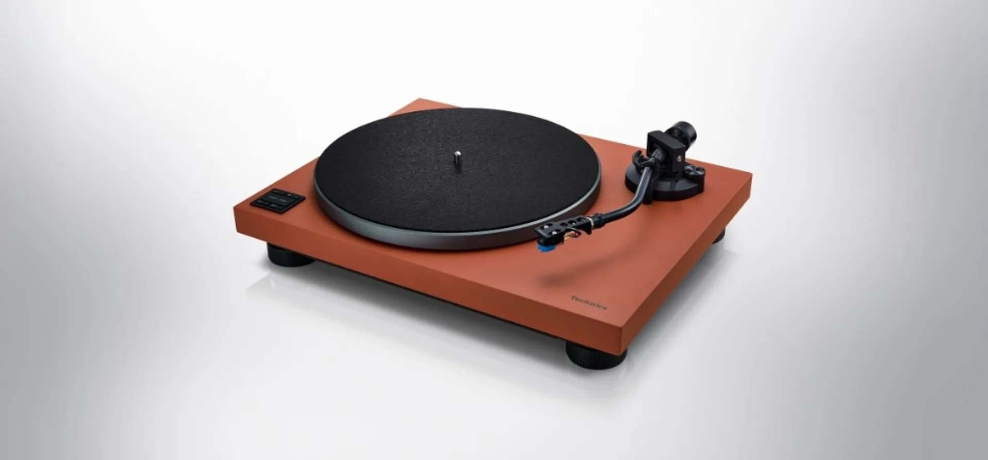 Technics SL-50C turntable in orange finish shown at a front angle.