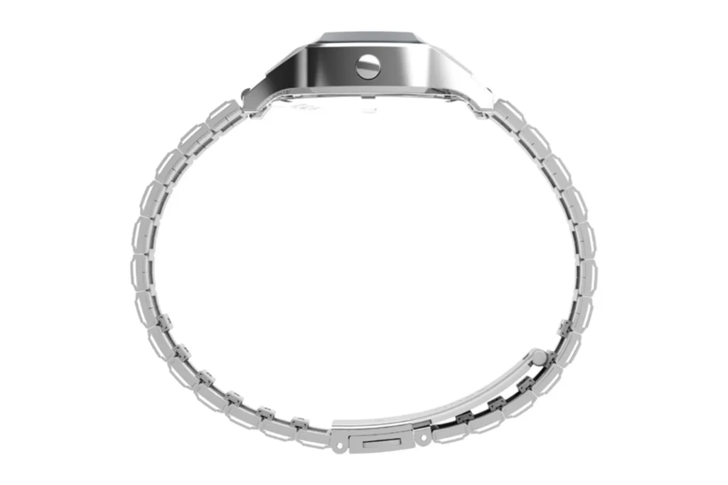 Side profile of Timex SSQ digital reissue: faceted steel case, side pusher, ladder-style link bracelet and clasp on white ba…