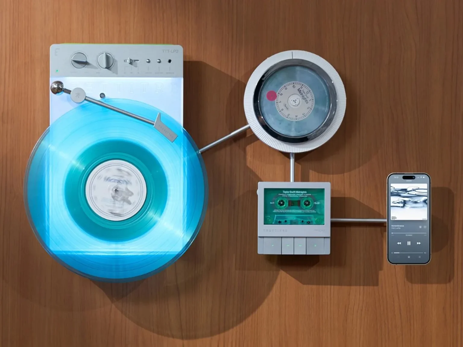 Top-down view of Trettitre TTT-LP3 vertical wireless turntable with glowing base, cyan vinyl, wall-mounted CD player, casset…