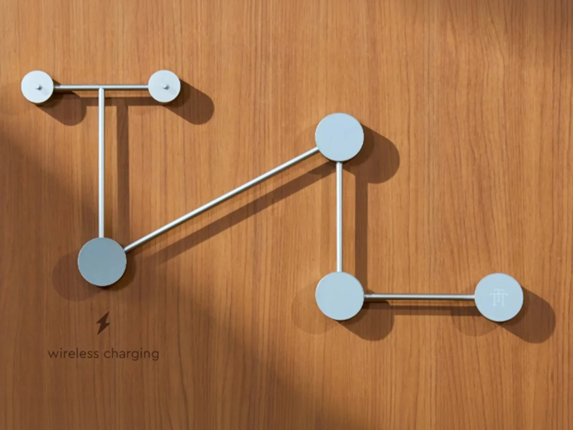Trettitre TTT-LP3 graphic: silver rod network with blue nodes on wood grain, lightning icon and wireless charging label.
