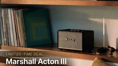 Promotional graphic: black Marshall Acton III on a wooden shelf beside vinyl records with limited-time deal text showing pri…