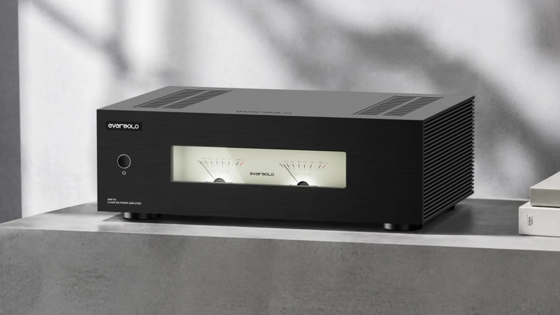 Eversolo AMP-F8 Class-AB power amplifier with dual backlit analog VU meters on brushed black metal chassis.