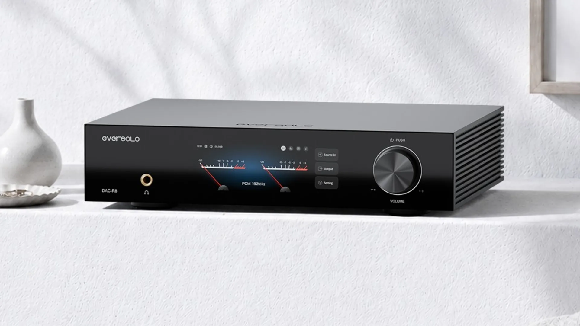Eversolo DAC-R8 R2R DAC with dual digital VU meters, gold headphone jack, and black chassis with cooling fins.