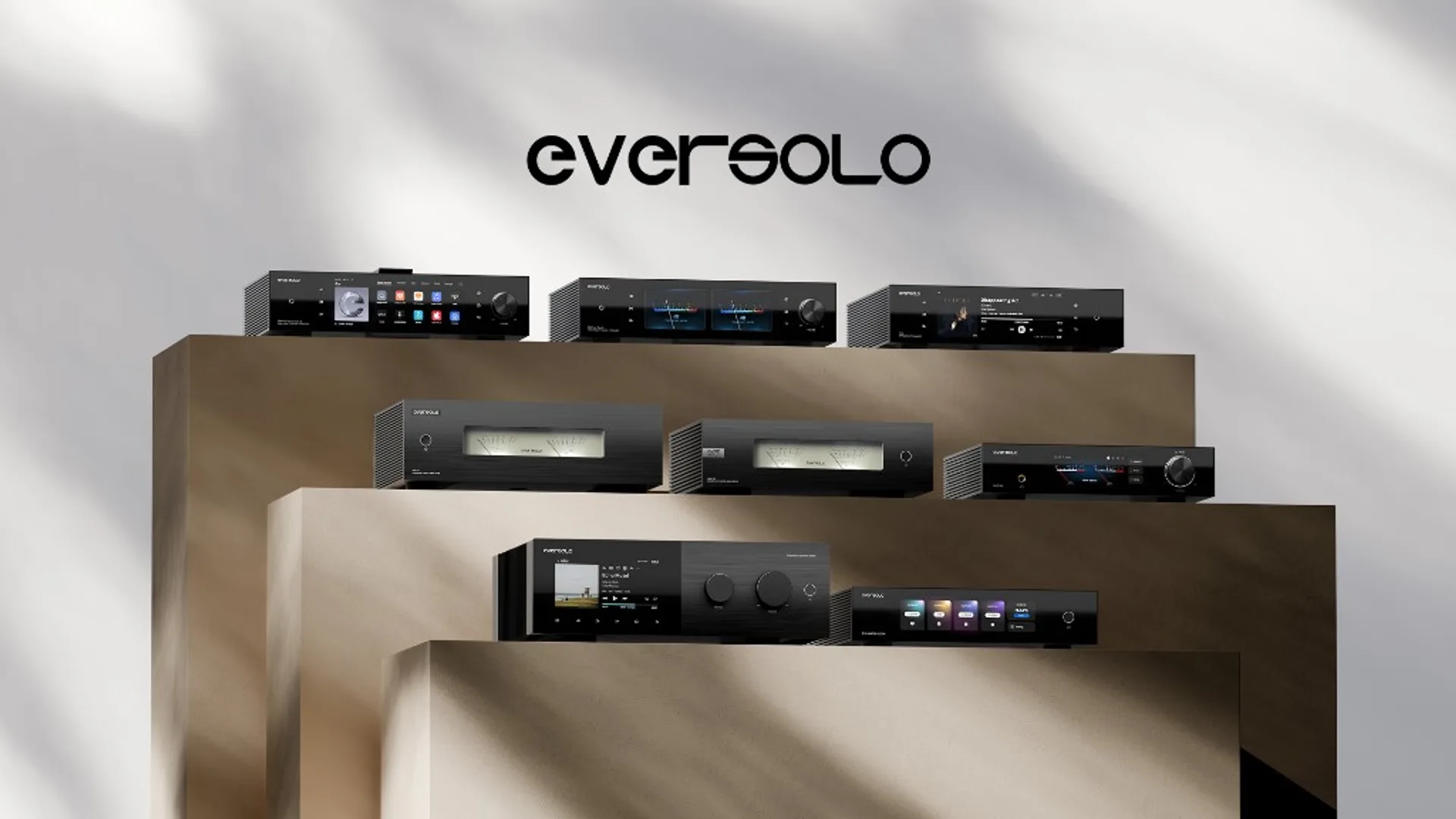 Five Eversolo high-end components including streamer with touchscreen and dual VU meter amplifiers on tiered display.