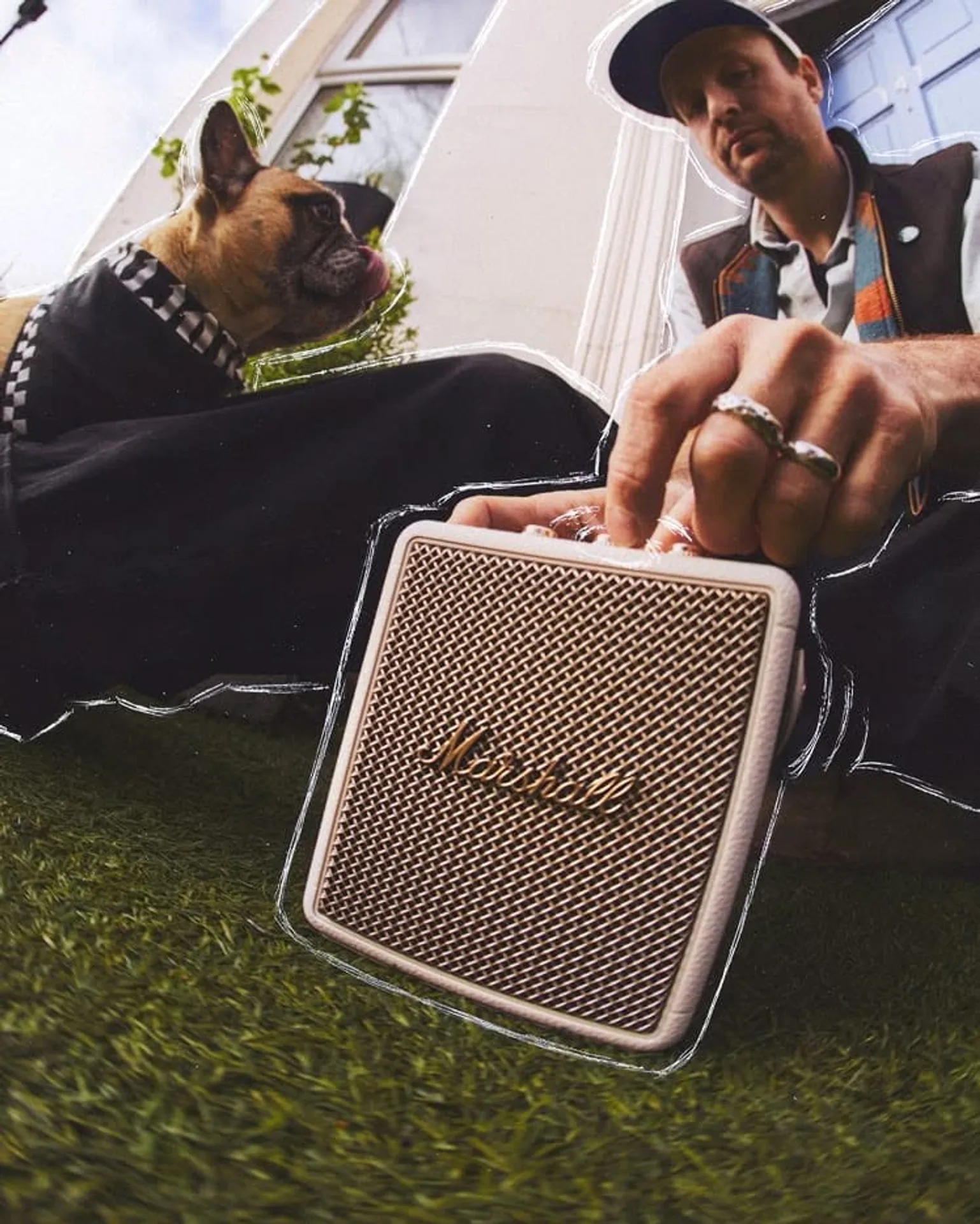 Marshall Stockwell III in Cream finish outdoors with hand adjusting brass volume knob on artificial turf.