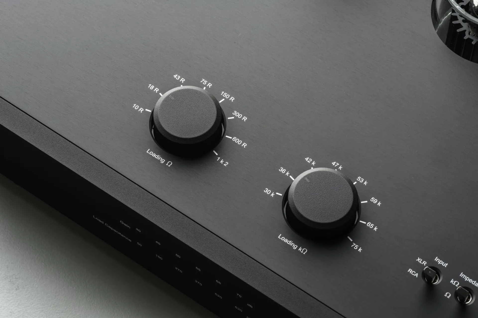Close-up of EAT E-Glo SB black phono stage brass loading and gain knobs