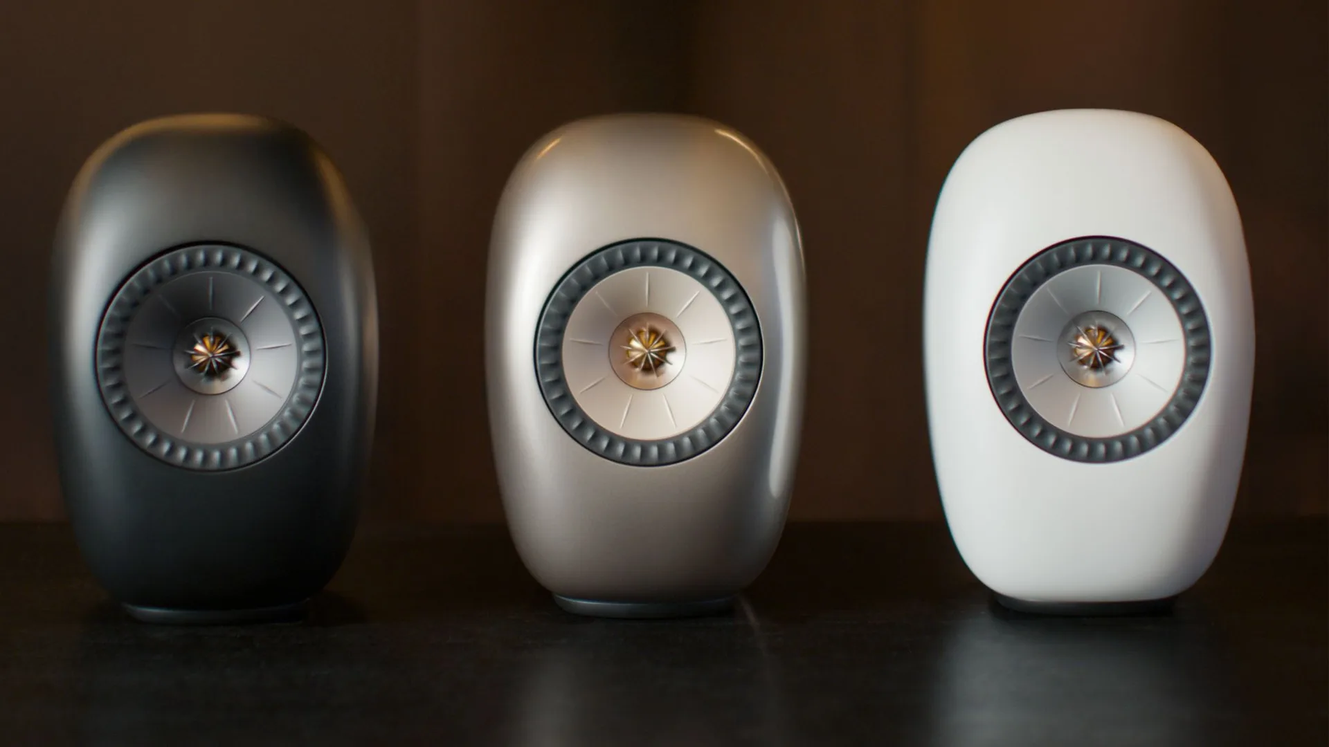 KEF LS LUXE wireless speakers in Eclipse Black, Dusk Titanium, and Mineral White finishes