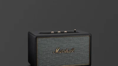 Marshall Acton IV Black home Bluetooth speaker with salt-and-pepper grille and brass top controls on dark grey background.