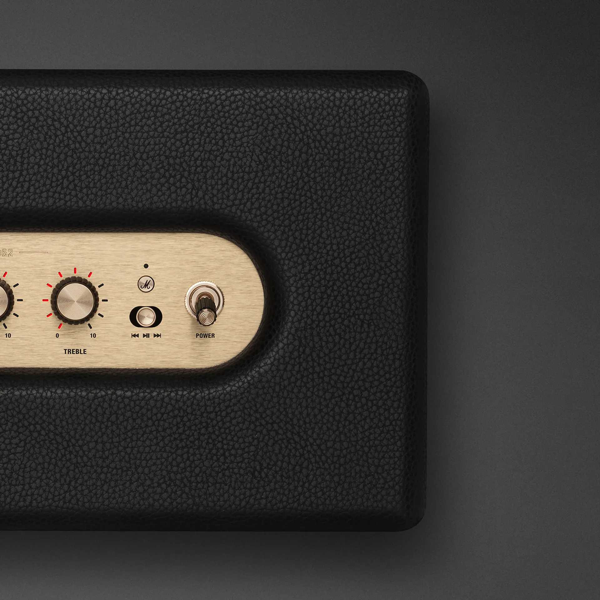 Marshall Stanmore IV brass control panel close-up with knobs and power toggle.