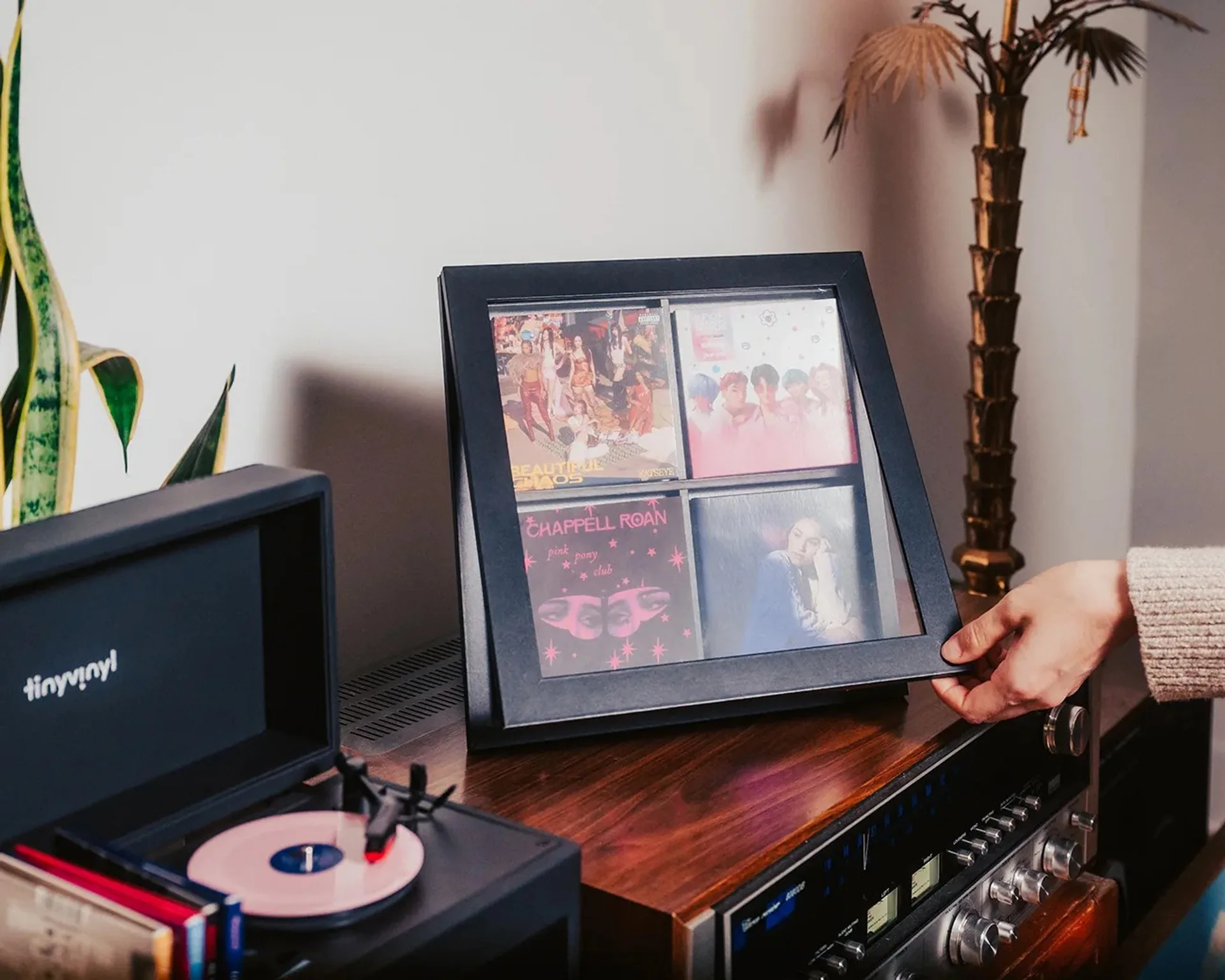 Tiny Vinyl 2x2 Frame displaying four miniature record jackets on a wall